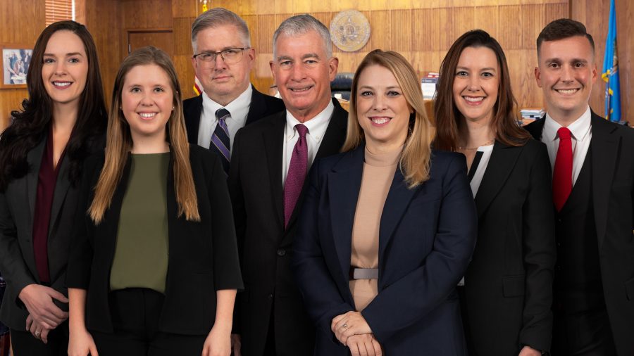 Photo of of litigators Phil Richards, Kelsie Sullivan, Jessica Battson, Mike Carr, Hunter Bailey, Emillie Cain, and Rachel Cory in a Tulsa County Courtroom
