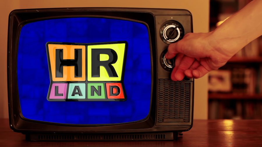 Image of person adjusting a vintage television set with the HR Land logo on the screen