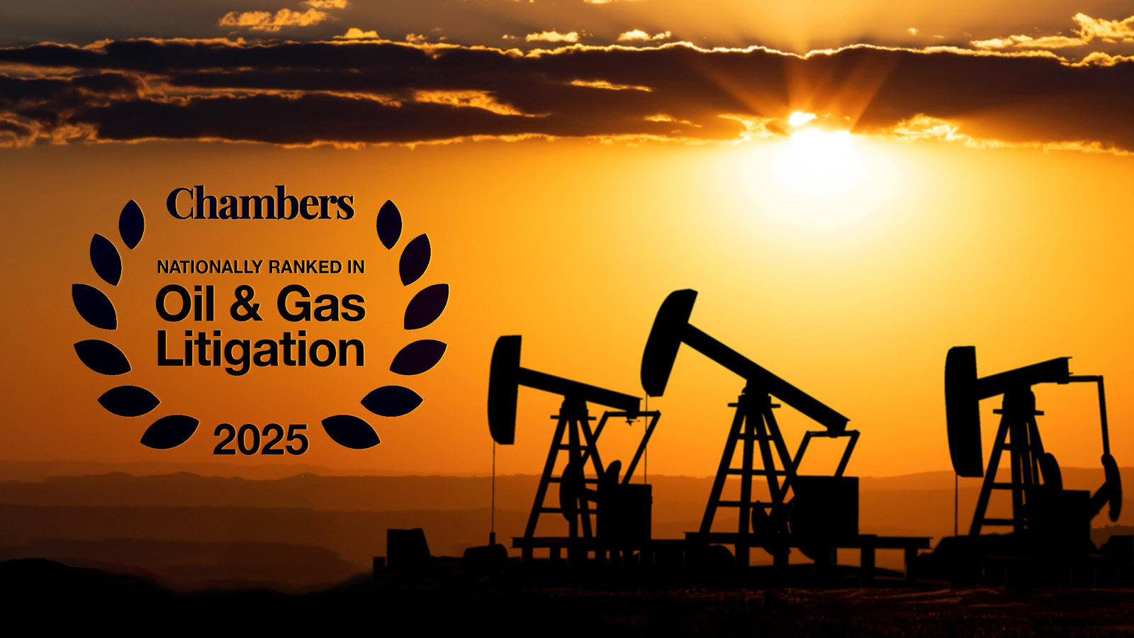 Silhouette image of oil pump jacks back lit by a sunset in western Oklahoma