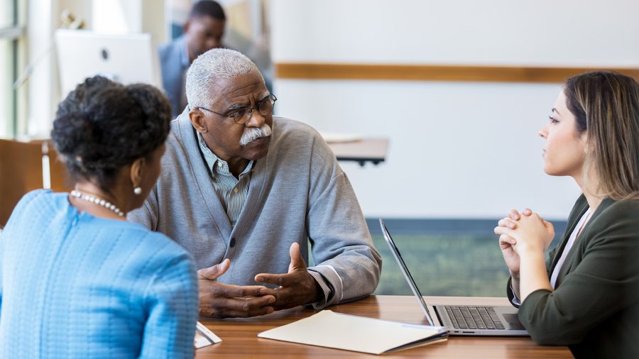 Senior man talks about fraud to his bank account.