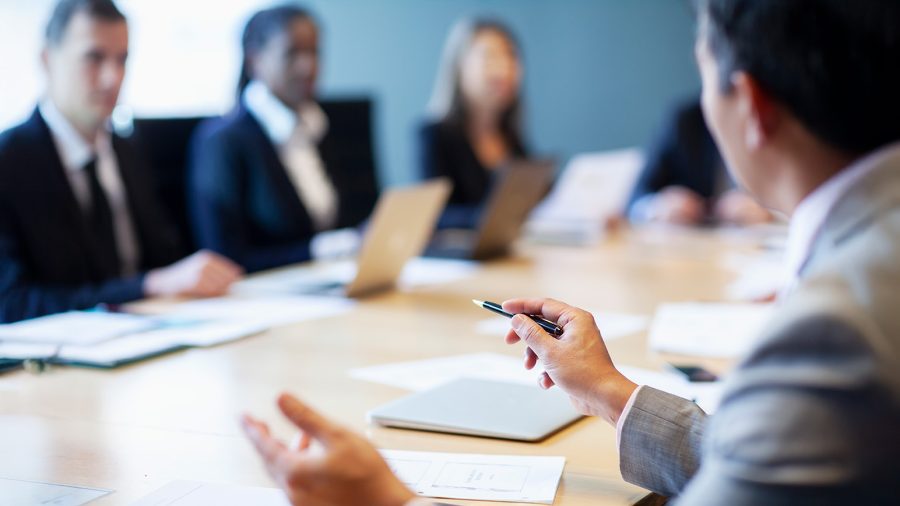 Corporate governance meeting of leadership in the executive boardroom.