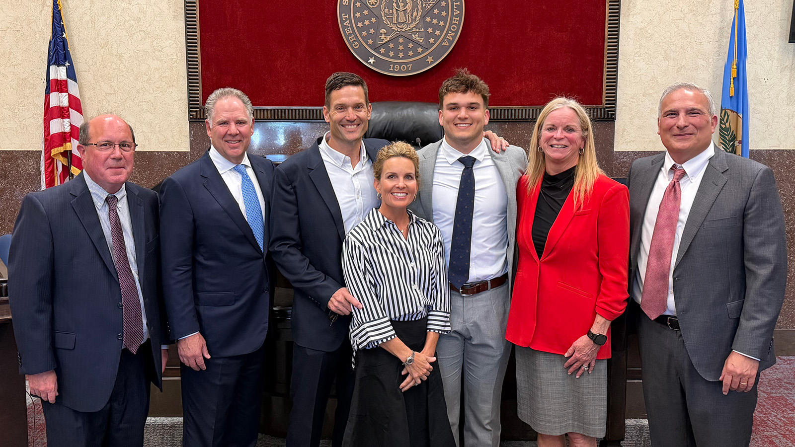 Photo of Owen Heinecke with his parents and his legal team; pictured from left to right are McAfee & Taft trial lawyer Andy Richardson, Norman local counsel Woody Glass, Justin and Hayden Heinecke (Owen's parents), Owen Heinecke, and McAfee & Taft trial lawyers Mary Quinn Cooper and Michael Lauderdale. Not pictured is McAfee & Taft trial lawyer Tyler Ames.