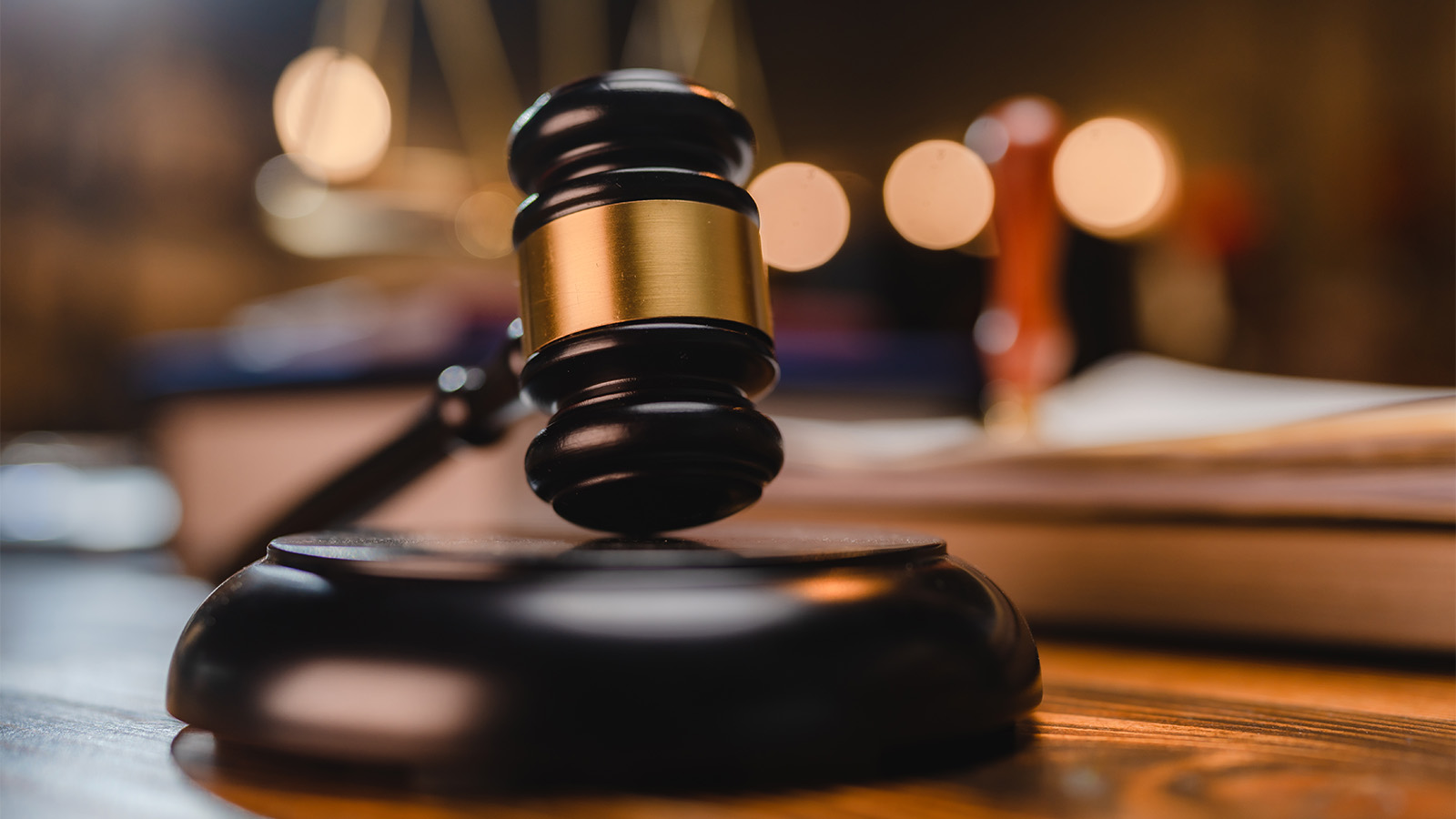 Gavel on the judge's desk in a courtroom [Source: Getty Images]