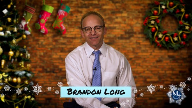 Photo of Brandon Long telling his favorite holiday memory about the really bad puppet moviethat has made really good memories