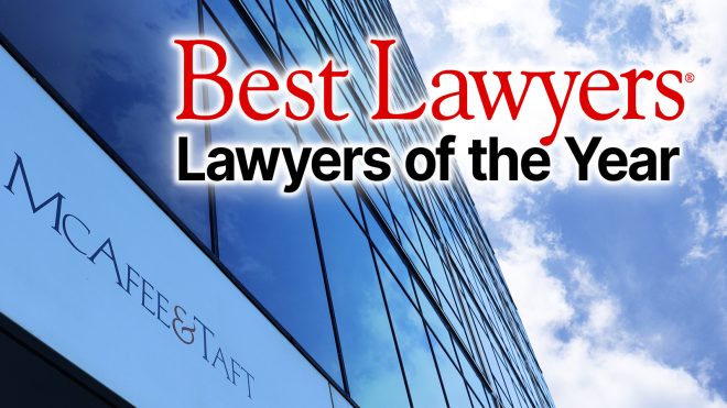 The text Best Lawyers: Lawyers of the Year superimposed over a glass office building featuring the McAfee & Taft logo.